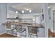Stylish eat-in kitchen with barstool seating, stainless appliances, and a light backsplash at 1912 Goose Creek Rd. Sw # 4302, Ocean Isle Beach, NC 28469