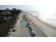 Aerial view of Myrtle Beach with beach umbrellas along the coast line at 201 76Th Ave. N # E3, Myrtle Beach, SC 29577