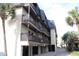 Condo building exterior with brown balconies and covered parking at 201 76Th Ave. N # E3, Myrtle Beach, SC 29577