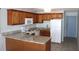 Well-lit kitchen with granite countertops, wooden cabinets, and white appliances at 201 76Th Ave. N # E3, Myrtle Beach, SC 29577