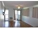 Bright living room with hardwood floors, a ceiling fan, and access to a balcony at 201 76Th Ave. N # E3, Myrtle Beach, SC 29577