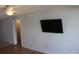 Well-lit living room featuring hardwood floors, a ceiling fan, and a mounted television at 201 76Th Ave. N # E3, Myrtle Beach, SC 29577