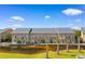 This townhome has an exterior view featuring balconies overlooking a scenic waterway, within a lush landscaped setting at 210 Double Eagle Dr. # B-2, Surfside Beach, SC 29575