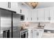 Well-appointed kitchen with stainless steel appliances, white cabinetry, and stylish modern fixtures at 210 Double Eagle Dr. # B-2, Surfside Beach, SC 29575