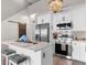 Open kitchen with a breakfast bar, white cabinets, and modern appliances, ideal for casual dining at 210 Double Eagle Dr. # B-2, Surfside Beach, SC 29575