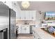 Bright kitchen featuring white cabinets, stainless appliances, and a view of the dining and living areas at 210 Double Eagle Dr. # B-2, Surfside Beach, SC 29575