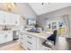 Open kitchen area with an island, white cabinets and adjacent living area, perfect for entertaining at 210 Double Eagle Dr. # B-2, Surfside Beach, SC 29575