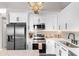 Bright, modern kitchen with stainless steel appliances, white cabinets, and stylish backsplash at 210 Double Eagle Dr. # B-2, Surfside Beach, SC 29575