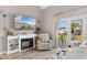 Bright living room features a fireplace, TV, and access to the balcony with a scenic neighborhood view at 210 Double Eagle Dr. # B-2, Surfside Beach, SC 29575
