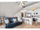 Bright open-concept living space with kitchen, island seating, living room and staircase behind a sliding barn door at 210 Double Eagle Dr. # B-2, Surfside Beach, SC 29575