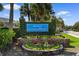 Beautifully landscaped welcome sign for the Grand Palms Resort, featuring lush greenery and colorful flower beds at 210 Double Eagle Dr. # B-2, Surfside Beach, SC 29575
