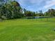 Large backyard featuring a large pond and a black metal fence at 2230 Ainsley Dr., Little River, SC 29566