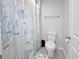 Neat bathroom featuring a shower with themed curtain, toilet and white walls at 2230 Ainsley Dr., Little River, SC 29566
