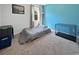 Cozy bedroom with blue accent wall, carpet, window and a dog crate at 2230 Ainsley Dr., Little River, SC 29566