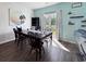 Inviting dining room with wood floors, a modern light fixture, and a sliding glass door to the outside at 2230 Ainsley Dr., Little River, SC 29566