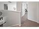 Upstairs hallway leads to a bedroom featuring a cat tree and bright natural light at 2230 Ainsley Dr., Little River, SC 29566