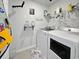 Functional laundry room with modern appliances and storage shelving at 2230 Ainsley Dr., Little River, SC 29566