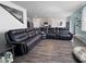 Open floor plan with the stairs, kitchen, and a leather couch in the living room at 2230 Ainsley Dr., Little River, SC 29566