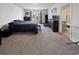 Spacious main bedroom features neutral carpeting, large window, and ensuite bathroom at 2230 Ainsley Dr., Little River, SC 29566