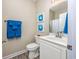 Bright bathroom features a white vanity, framed artwork, and coordinating blue towels at 2405 Duffy St., North Myrtle Beach, SC 29582