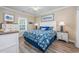 This bedroom features coastal decor, a patterned bedspread, and wood-look floors at 2405 Duffy St., North Myrtle Beach, SC 29582