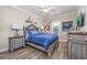 This bedroom boasts charming decor with a patterned bedspread and wood-look floors at 2405 Duffy St., North Myrtle Beach, SC 29582