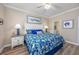 Bright bedroom features coastal decor, a patterned bedspread, and an ensuite bathroom at 2405 Duffy St., North Myrtle Beach, SC 29582