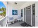 Welcoming front porch with seating, coastal decor, and a stylish entry door at 2405 Duffy St., North Myrtle Beach, SC 29582