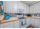 Bright kitchen features white cabinetry, tiled backsplash, and modern appliances at 2405 Duffy St., North Myrtle Beach, SC 29582