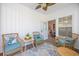 Comfortable sunroom featuring wicker chairs, ceiling fan, and views to the backyard at 2405 Duffy St., North Myrtle Beach, SC 29582