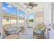 Inviting sunroom with wicker furniture, ceiling fan, and lots of natural light at 2405 Duffy St., North Myrtle Beach, SC 29582