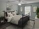 Comfortable bedroom with a plush rug, black metal bed frame, and gallery wall art at 251 Egret Run Ln. # 1122, Pawleys Island, SC 29585