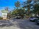 Scenic parking area with nearby shops featuring lush trees and blue skies at 251 Egret Run Ln. # 1122, Pawleys Island, SC 29585