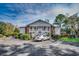 Inviting two-story condo featuring white siding and a charming exterior staircase and landscaping at 251 Egret Run Ln. # 1122, Pawleys Island, SC 29585