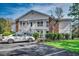 Inviting two-story condo featuring white siding and a charming exterior staircase and landscaping at 251 Egret Run Ln. # 1122, Pawleys Island, SC 29585