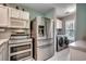 Updated kitchen featuring stainless steel refrigerator and modern washer and dryer units at 251 Egret Run Ln. # 1122, Pawleys Island, SC 29585