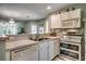 Bright kitchen featuring sleek appliances, white cabinetry and a double basin sink at 251 Egret Run Ln. # 1122, Pawleys Island, SC 29585