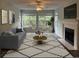 Inviting living room with fireplace, comfortable seating, and natural light from large windows at 251 Egret Run Ln. # 1122, Pawleys Island, SC 29585