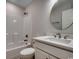 Bright bathroom featuring a shower-tub combo and a vanity with a round mirror at 2599 Woodcreek Ln., Conway, SC 29527