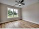 Bright bedroom with wood flooring and a view from the window at 2599 Woodcreek Ln., Conway, SC 29527