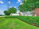 Entrance to Woodcreek featuring lush landscaping and a brick and white metal sign at 2599 Woodcreek Ln., Conway, SC 29527