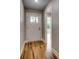 Bright entryway featuring a white front door with glass panel and beautiful hardwood flooring at 2599 Woodcreek Ln., Conway, SC 29527