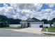 Single-Gathering home with gray siding, a two-car garage, and a well-manicured lawn at 2599 Woodcreek Ln., Conway, SC 29527