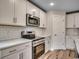 Well-lit kitchen with white cabinets, stainless steel appliances, subway tile backsplash, and light hardwood floors at 2599 Woodcreek Ln., Conway, SC 29527