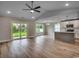 Open-concept living space with hardwood floors and access to the kitchen and patio at 2599 Woodcreek Ln., Conway, SC 29527