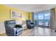 Bright living room featuring cozy chairs, stylish lamps, and a sliding glass door to the balcony with ocean views at 2801 S Ocean Blvd. # 538, North Myrtle Beach, SC 29582