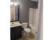 Bathroom featuring a dark vanity, bathtub, and toilet at 281 Palmetto Glen Dr., Myrtle Beach, SC 29588