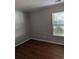 Bedroom with dark wood flooring, a window for natural light, and neutral-colored walls at 281 Palmetto Glen Dr., Myrtle Beach, SC 29588