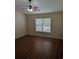 Bright bedroom features wood flooring, ceiling fan, and large window for natural light at 281 Palmetto Glen Dr., Myrtle Beach, SC 29588