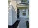 Inviting entryway with black front door, sidelight, and view of the covered front porch at 281 Palmetto Glen Dr., Myrtle Beach, SC 29588